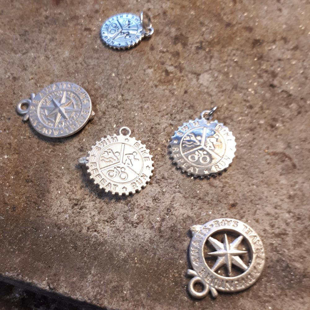 silver pendants on a jewellery bench