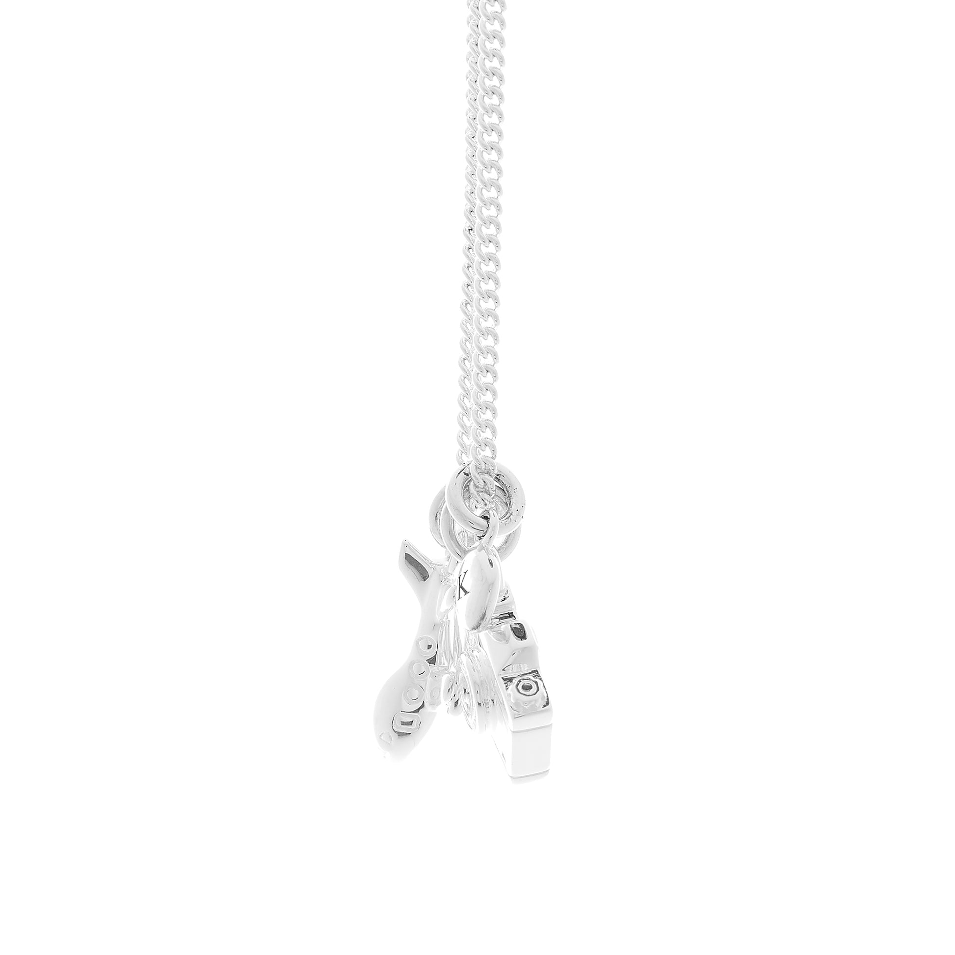 Silver necklace with aeroplane camera and pebble charms side view