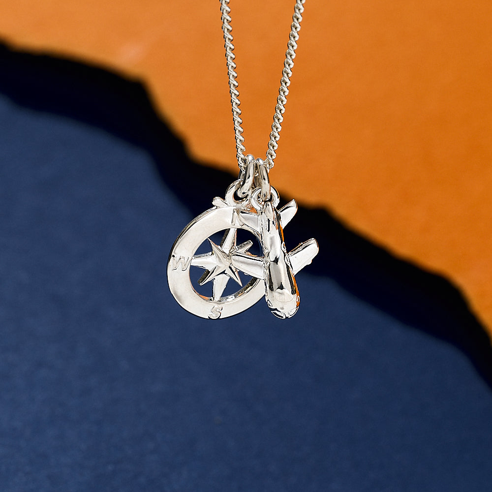 Silver necklace aeroplane and compass 