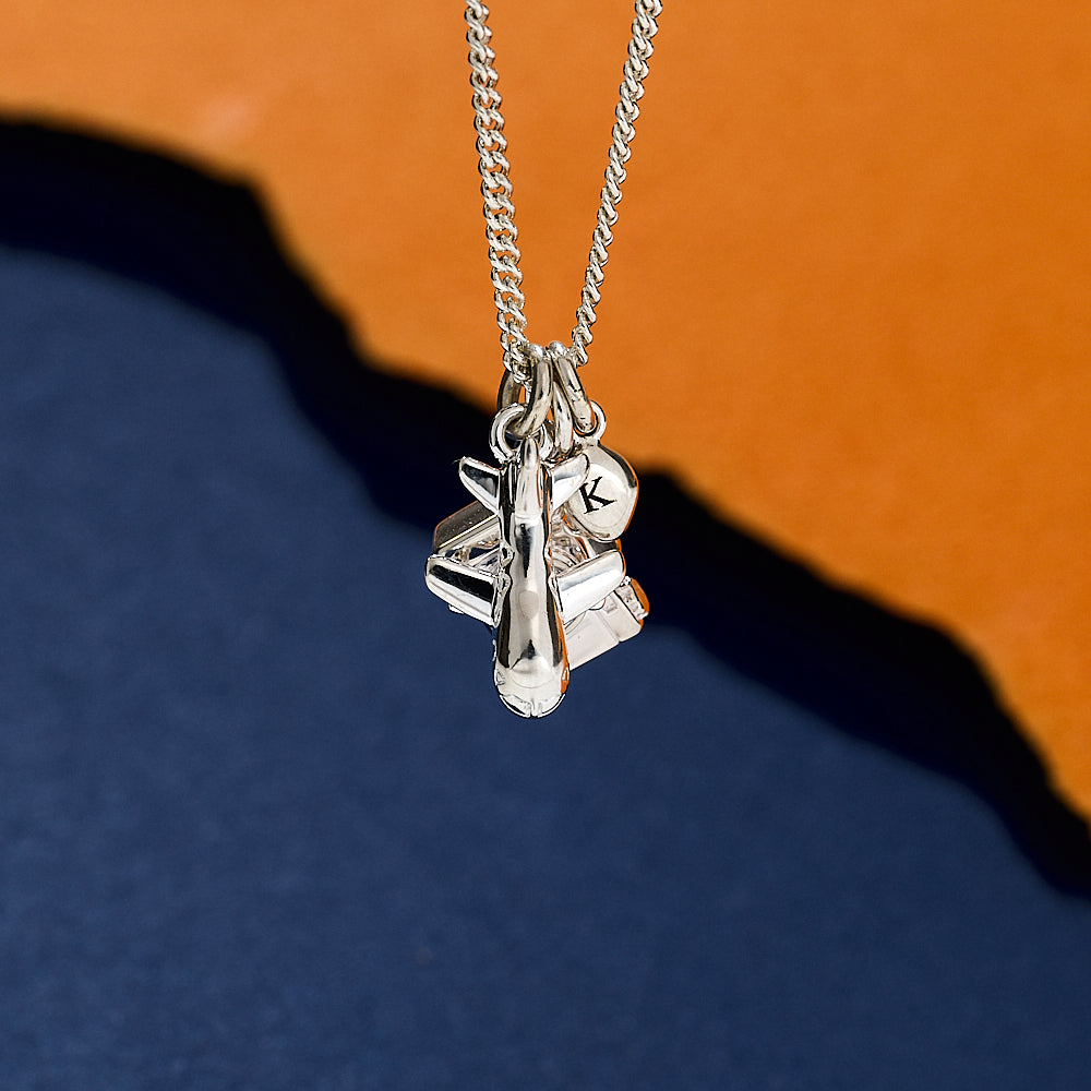 Silver necklace with aeroplane camera and pebble charms