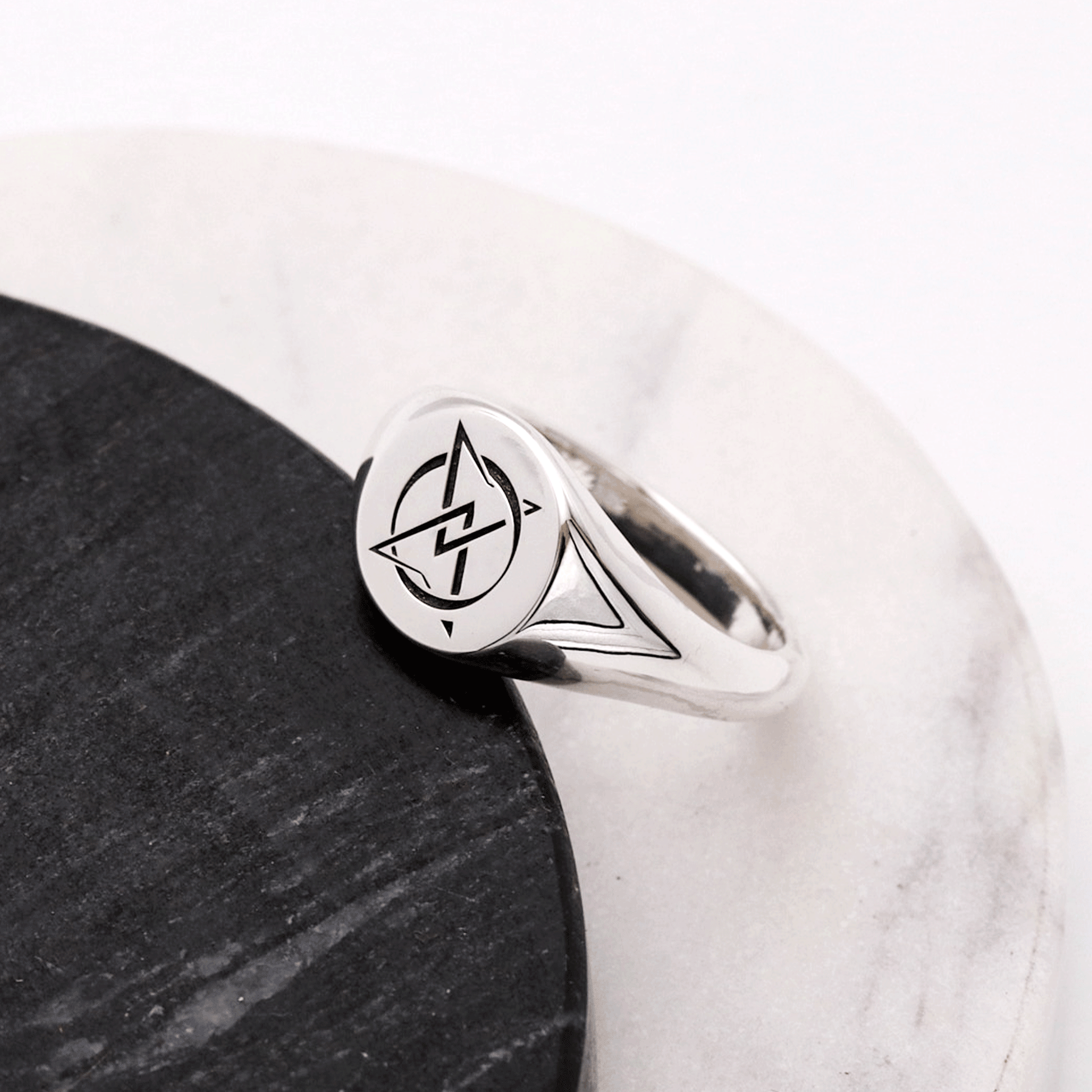 Silver ring with a unique design on a white and black background