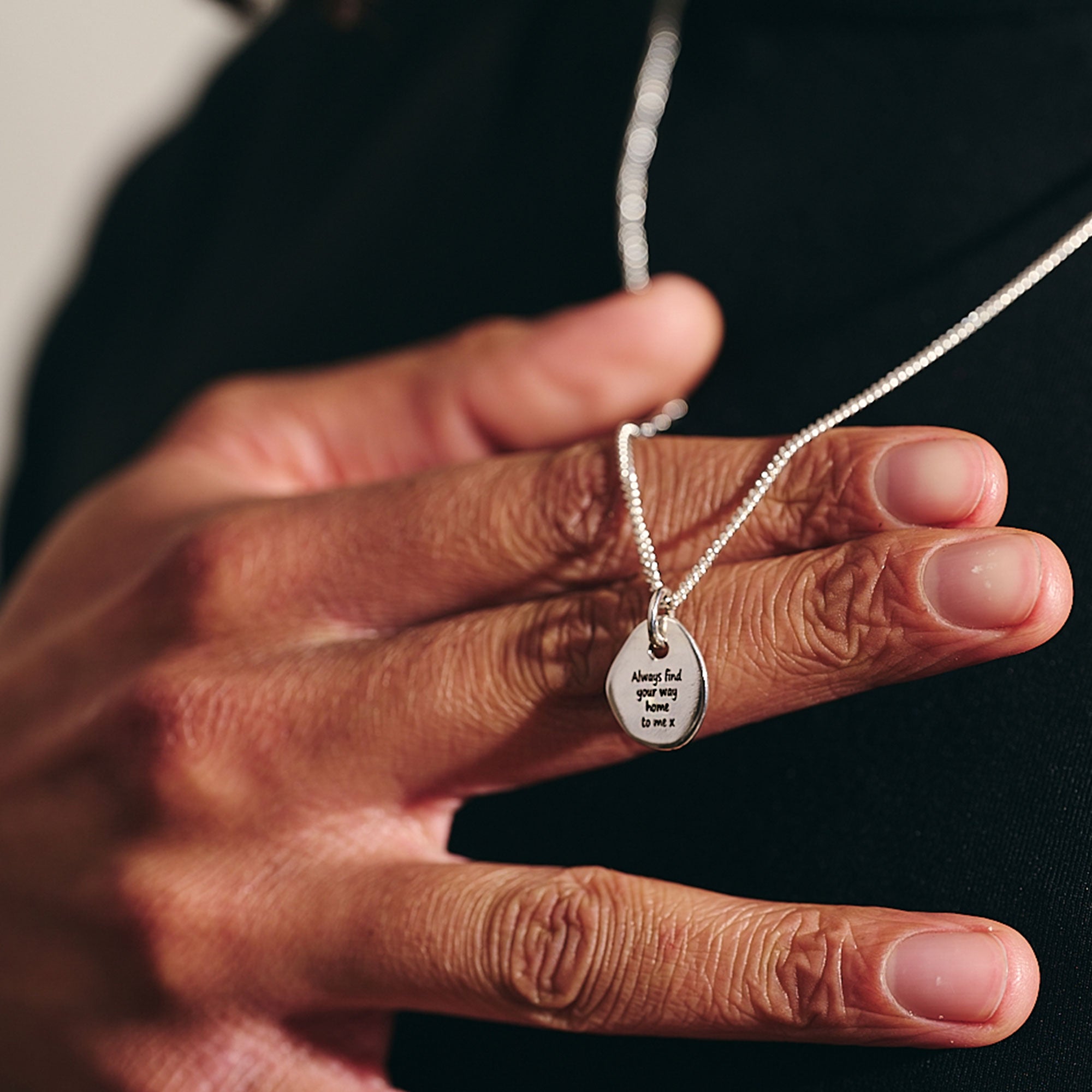 engraved back of rune necklace with heavier curb chain