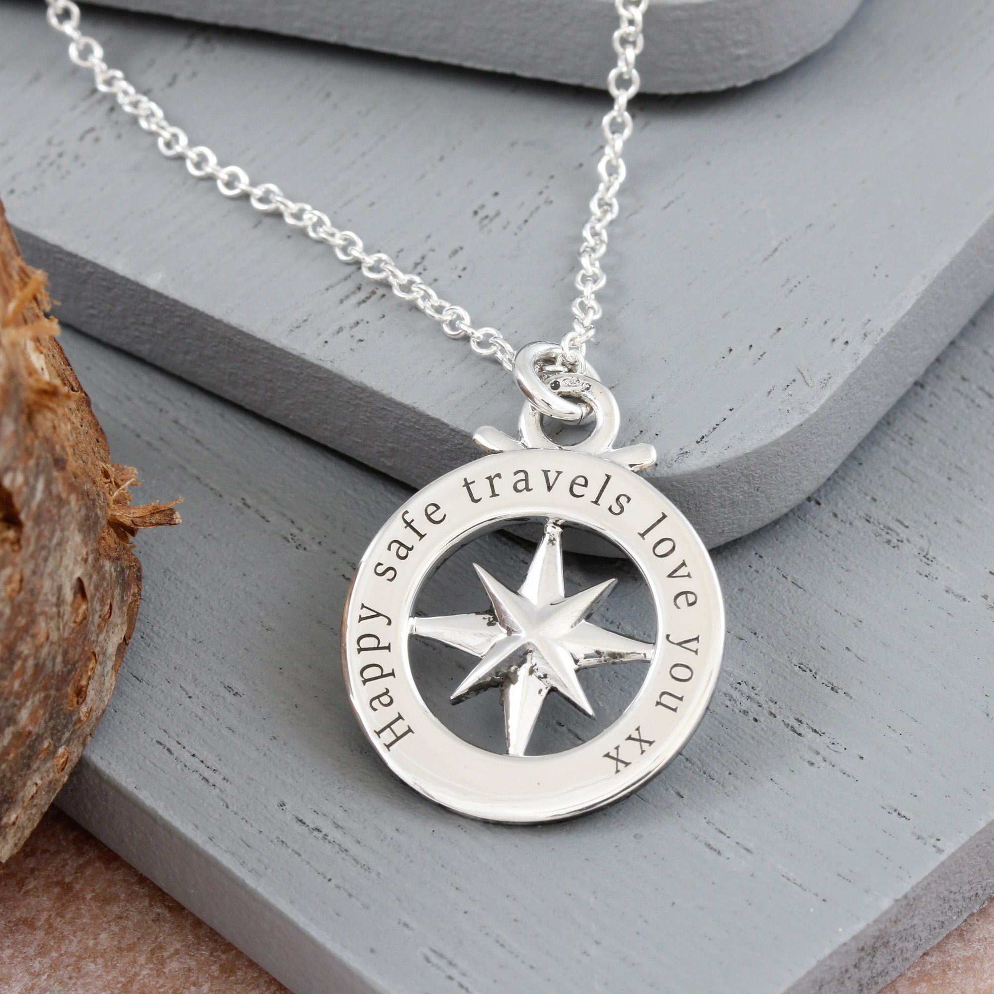 back of small outline compass necklace engraved on trace chain