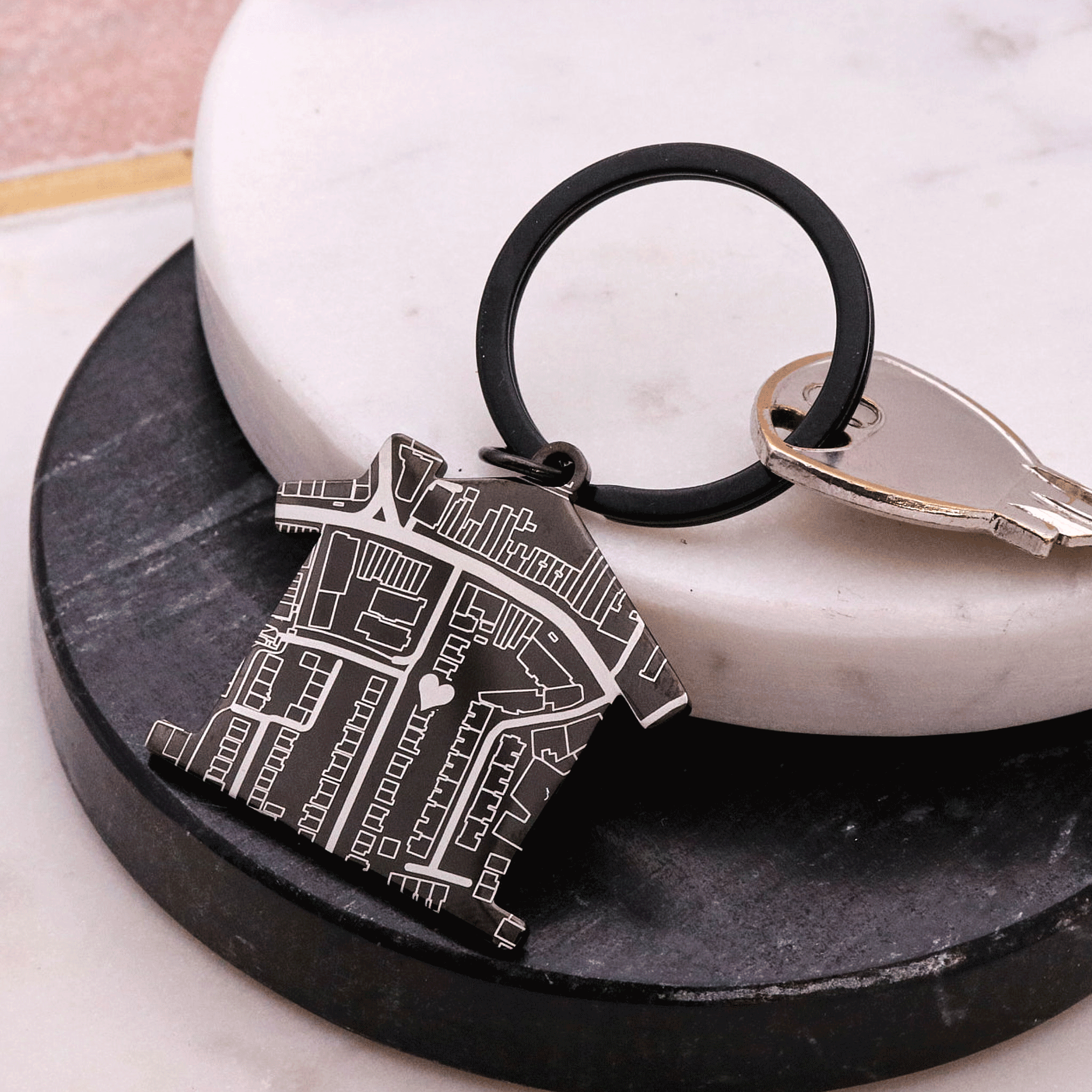 Black house shaped silver keyring with map design