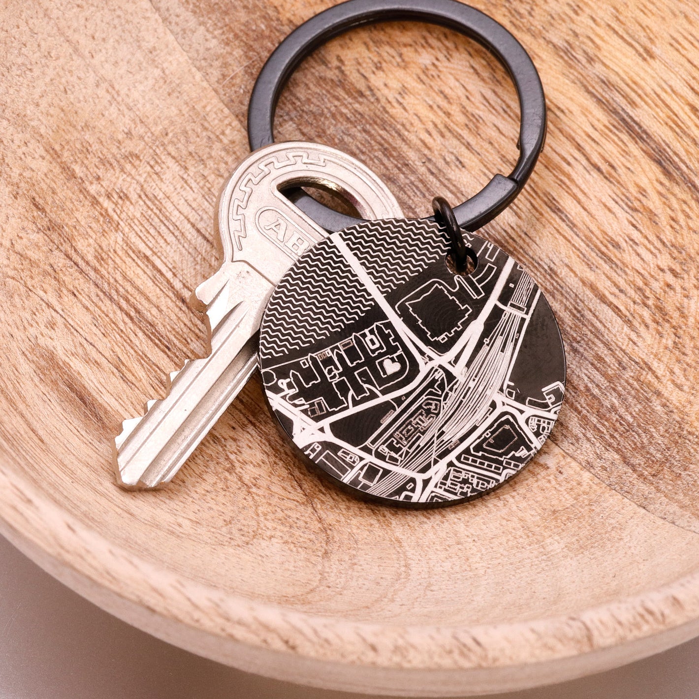 Keychain with key attached on a wooden surface