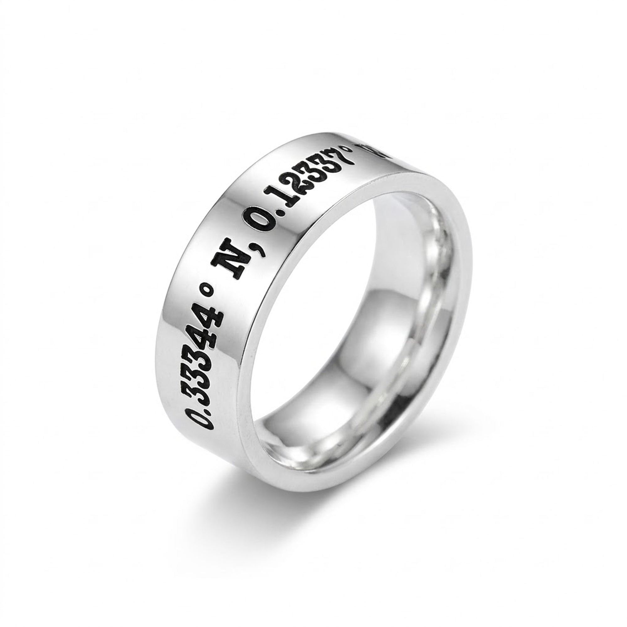 Silver ring with engraved coordinates on a white background
