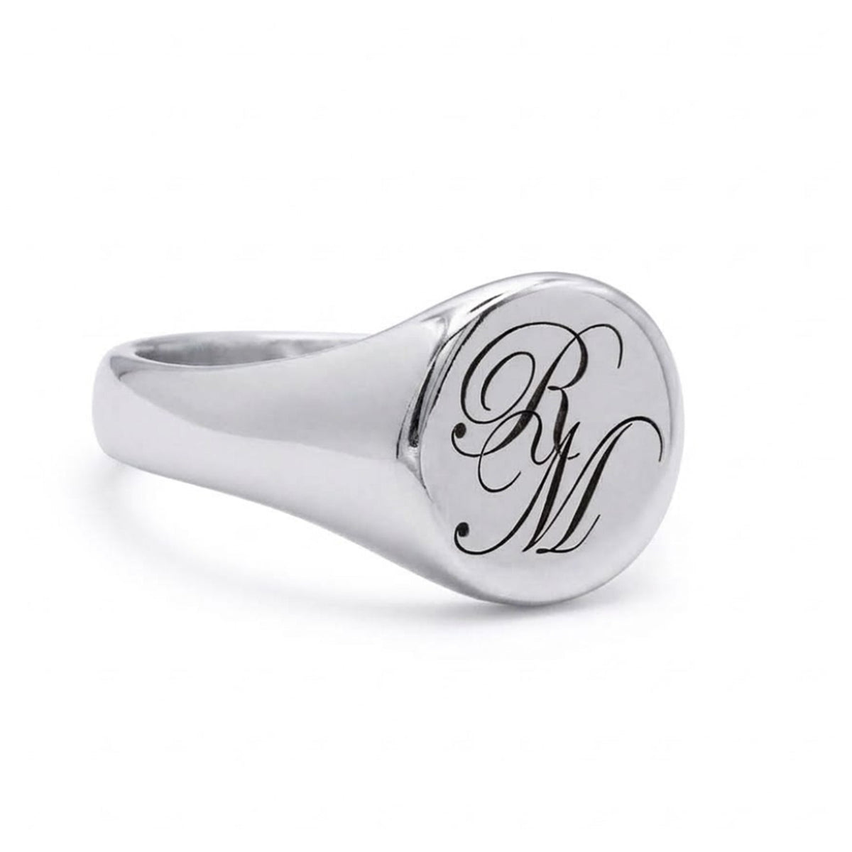 A polished silver signet ring featuring an engraved black cursive monogram 'R&M' on its round face, set against a clean white background.