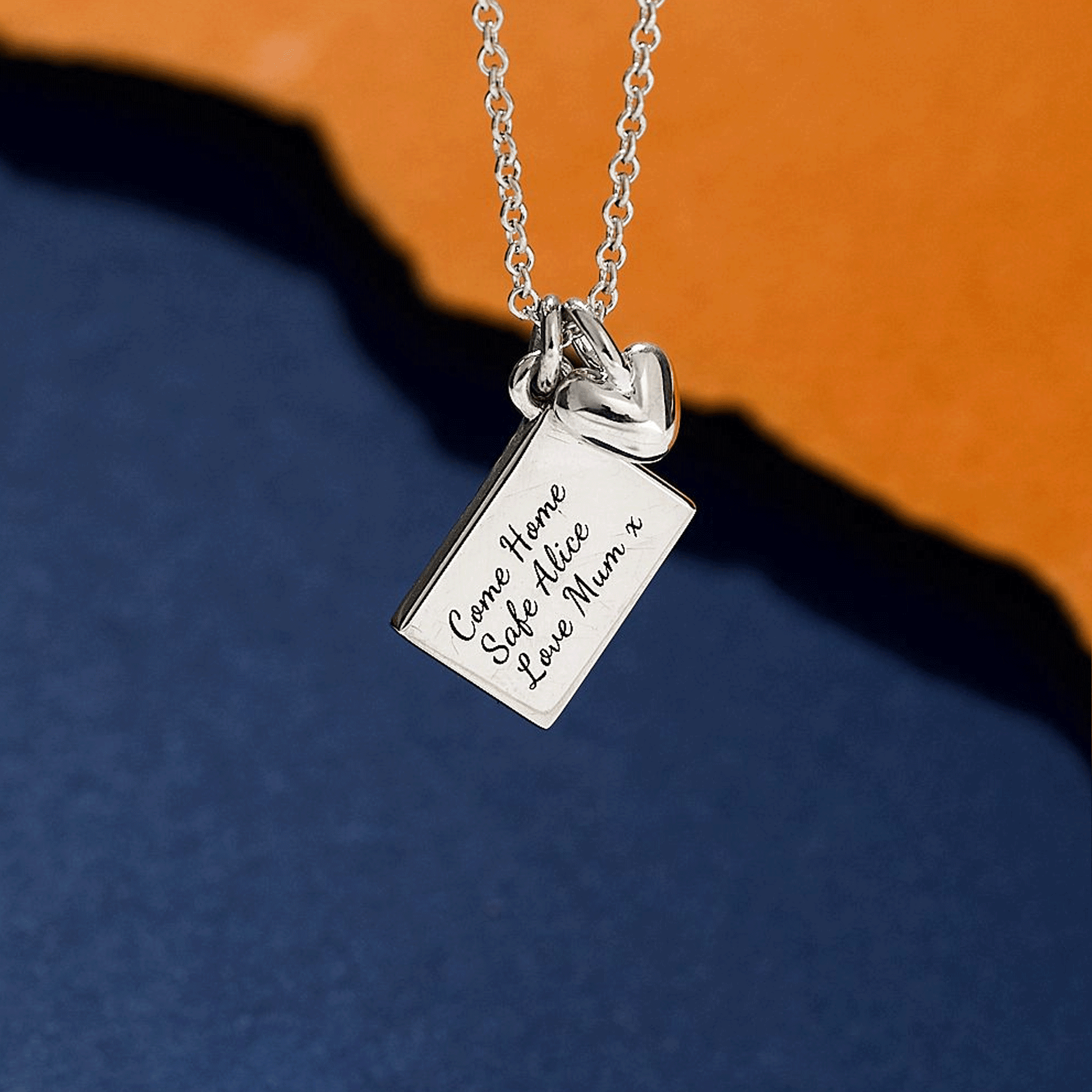 Silver necklace with a postcard personalised pendant and heart off the map jewellery back view