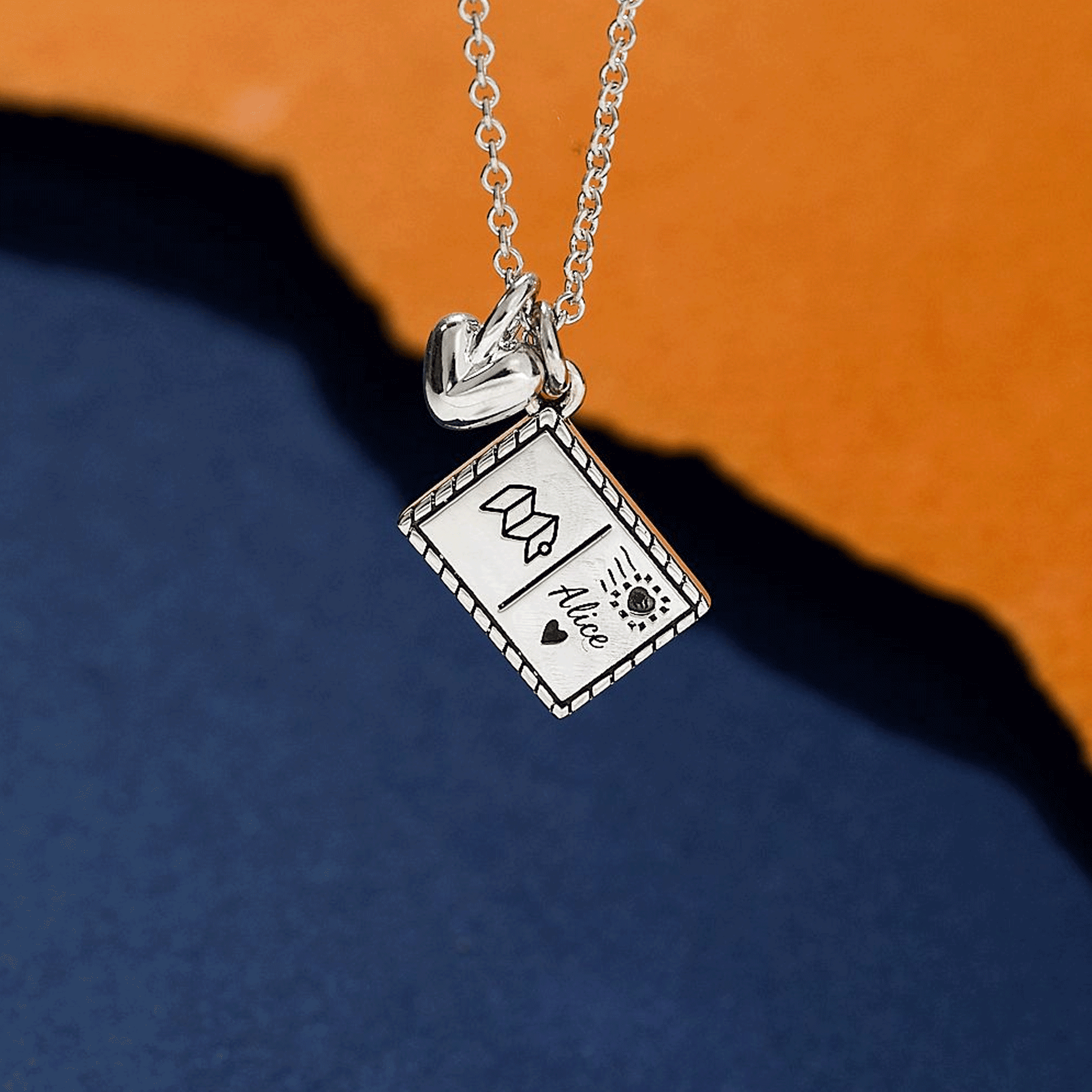 Silver necklace with a postcard personalised pendant and heart off the map jewellery