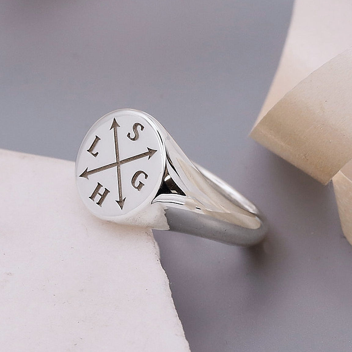 silver signet ring engraved with initials