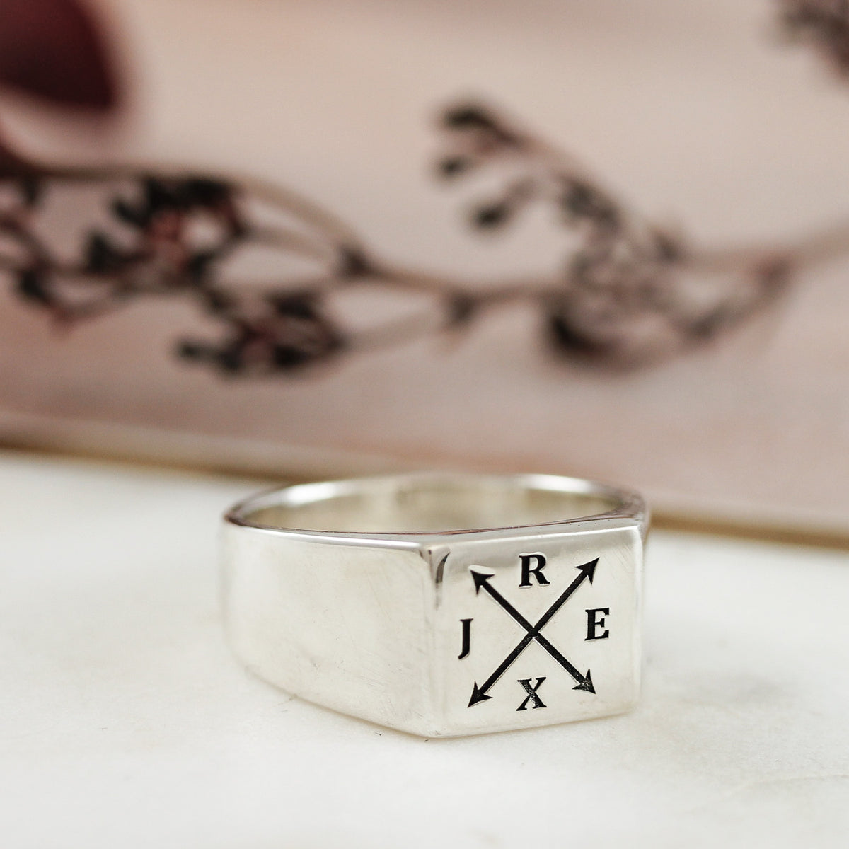 silver mans square faced signet ring engraved with arrows and initials