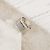 large square silver signet ring with engraved initials script font