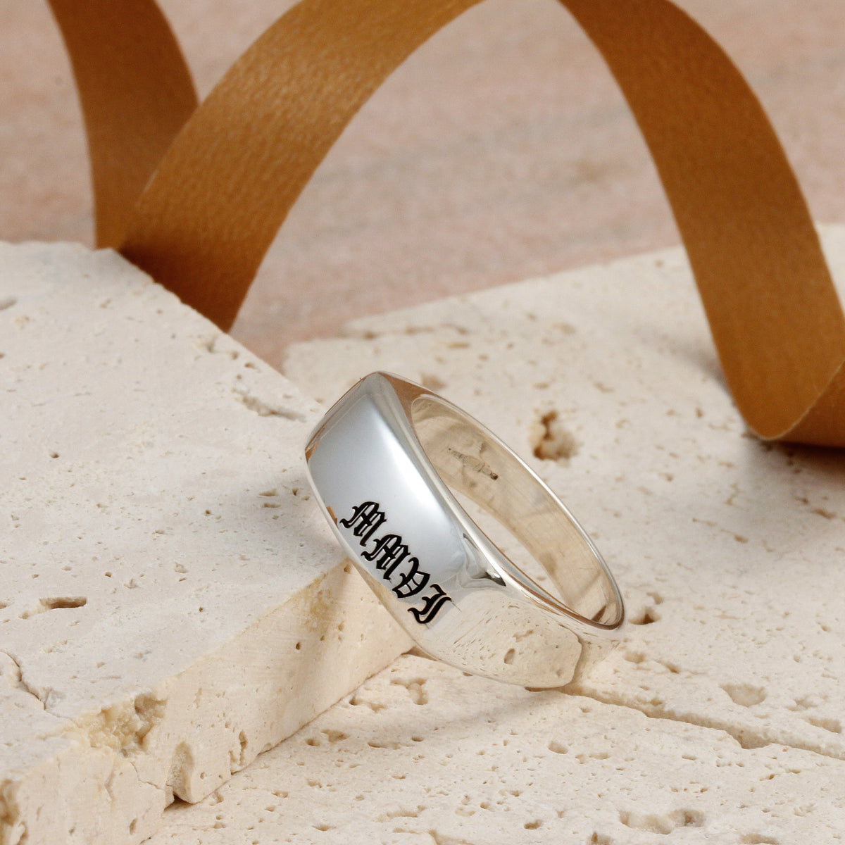 roman numerals engraving in olde english font on silver signet ring