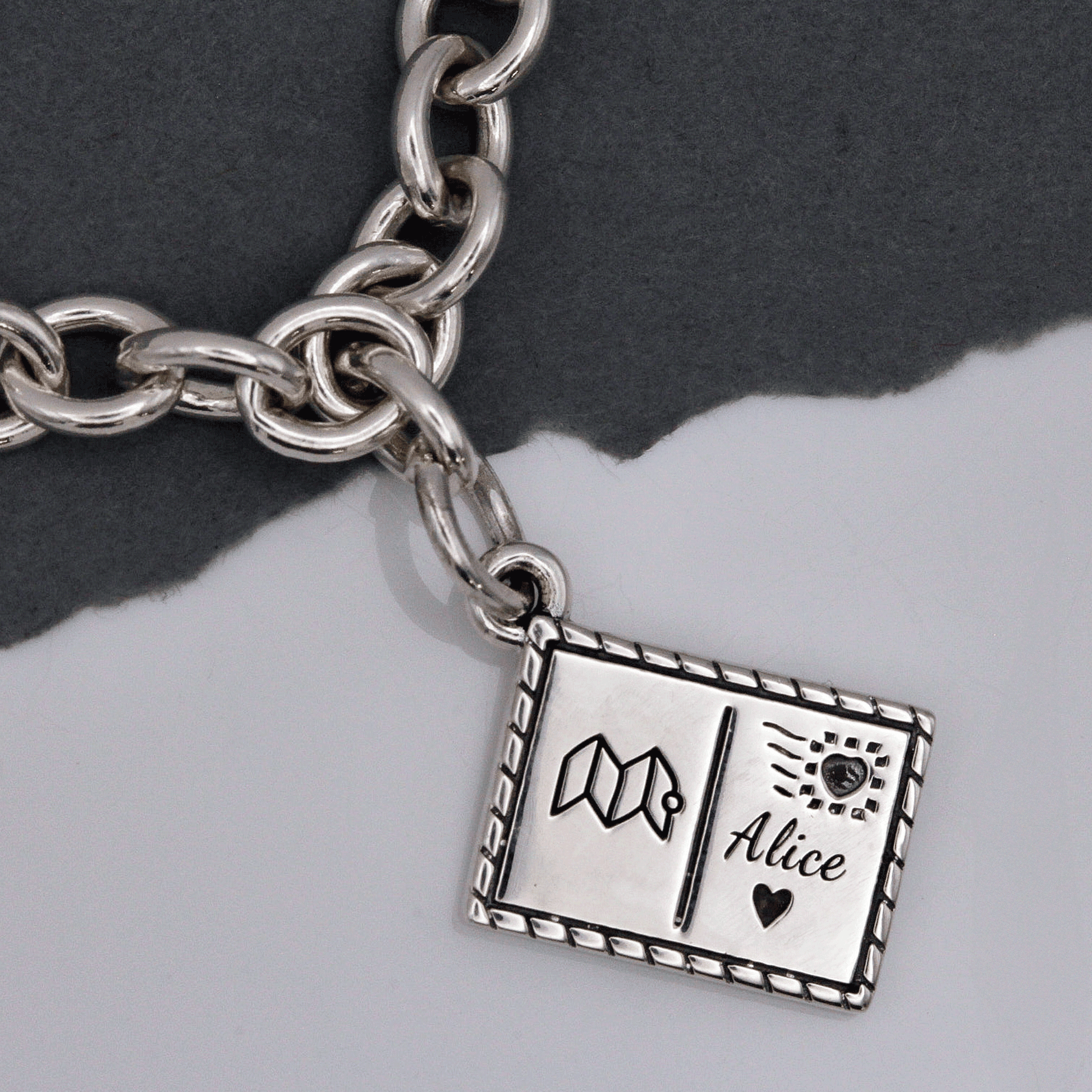 Silver postcard with personalised name and symbols by Off The Map Jewellery charm bracelet