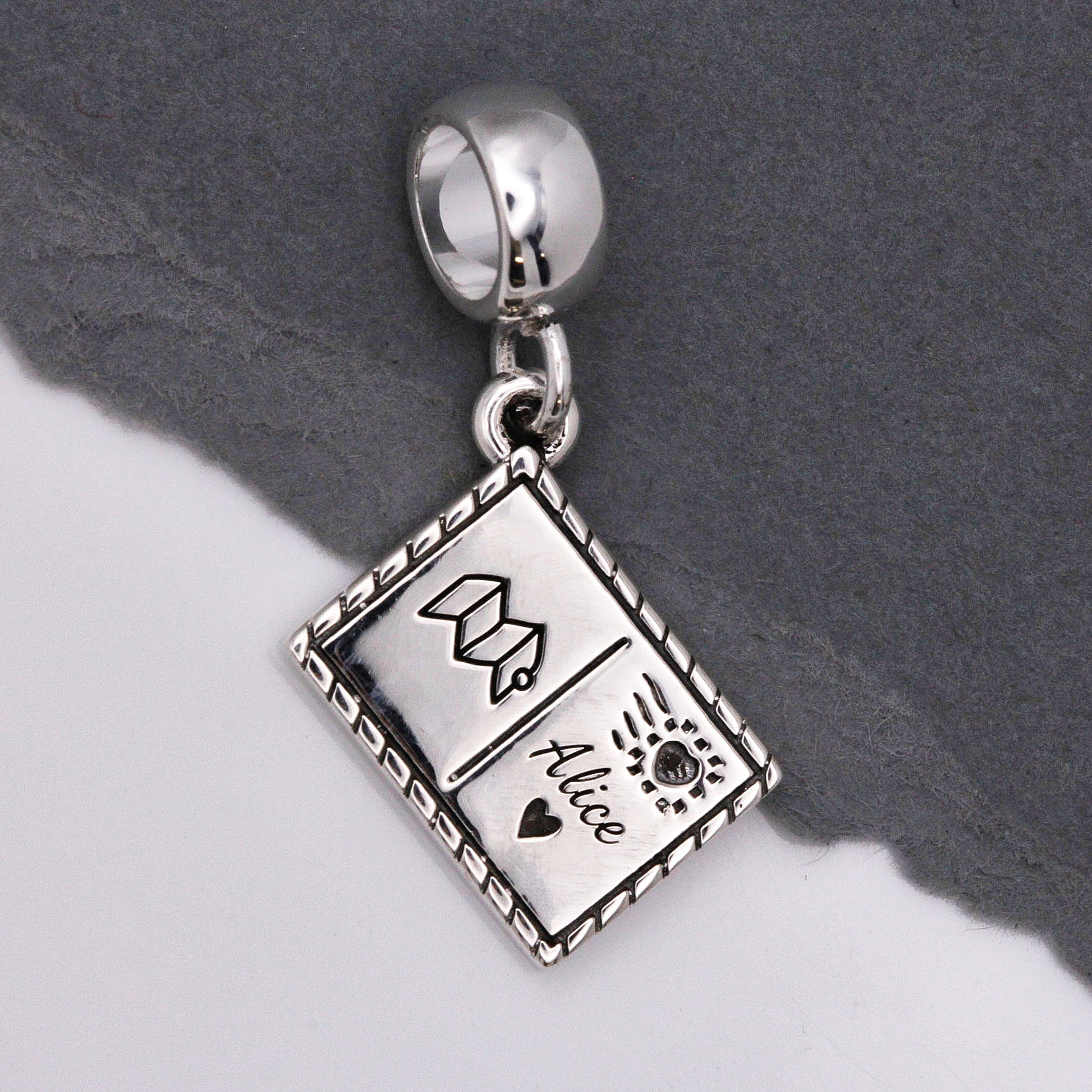 Silver postcard with personalised name and symbols by Off The Map Jewellery charm carrier
