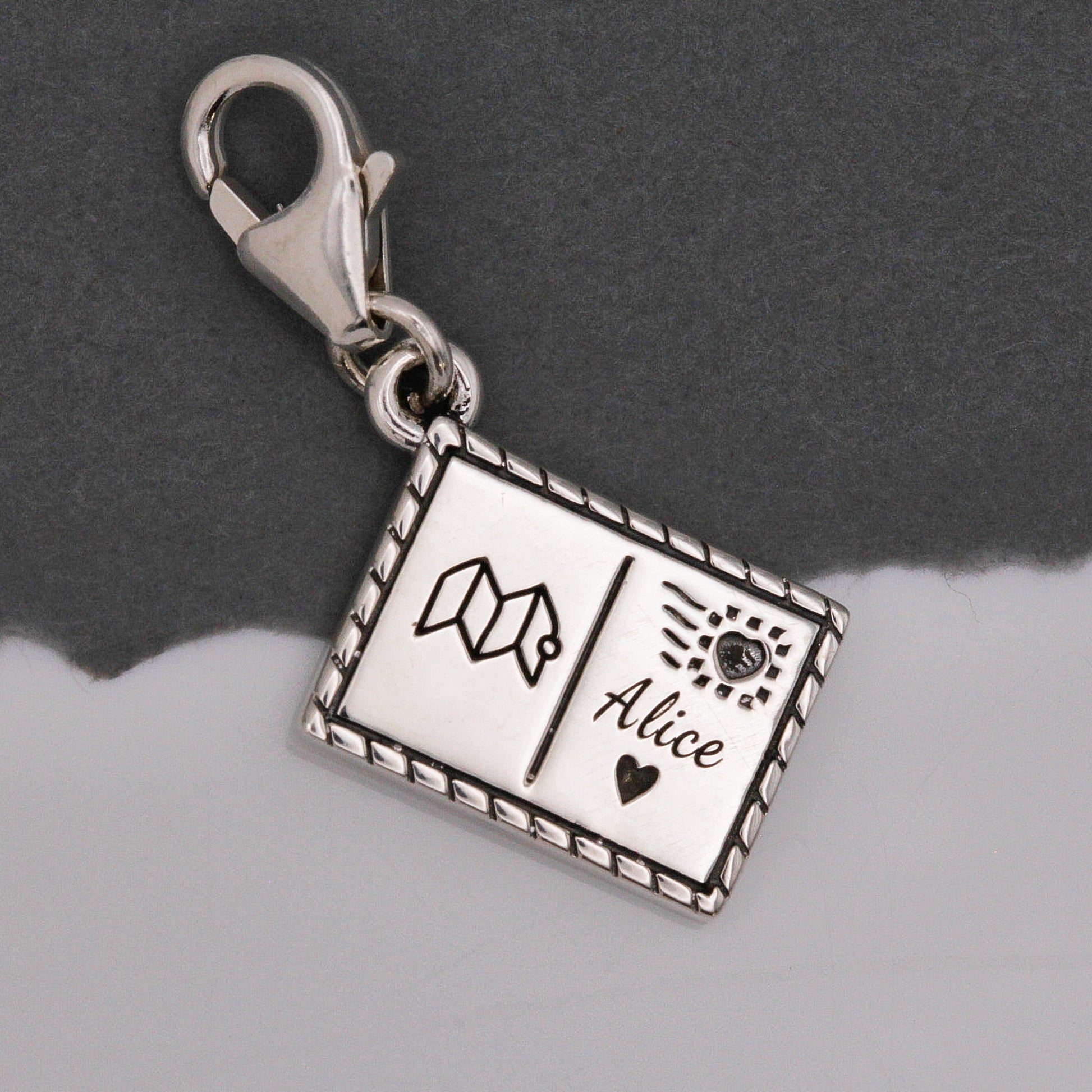 Silver postcard with personalised name and symbols by Off The Map Jewellery clip on clasp