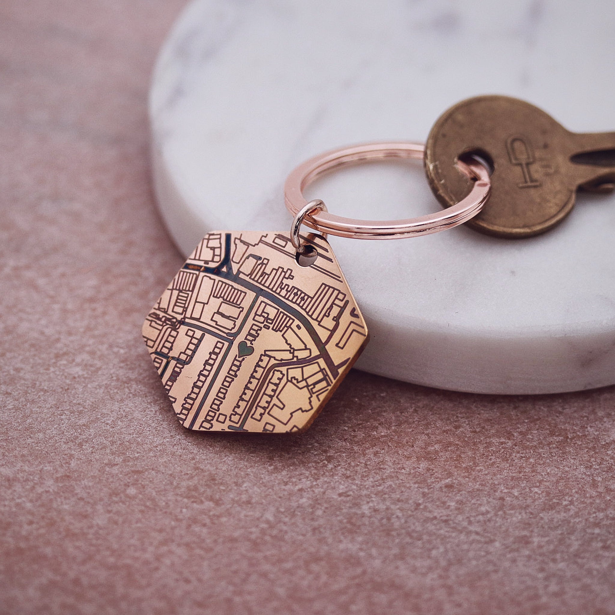 Keychain with engraved design on a marble surface