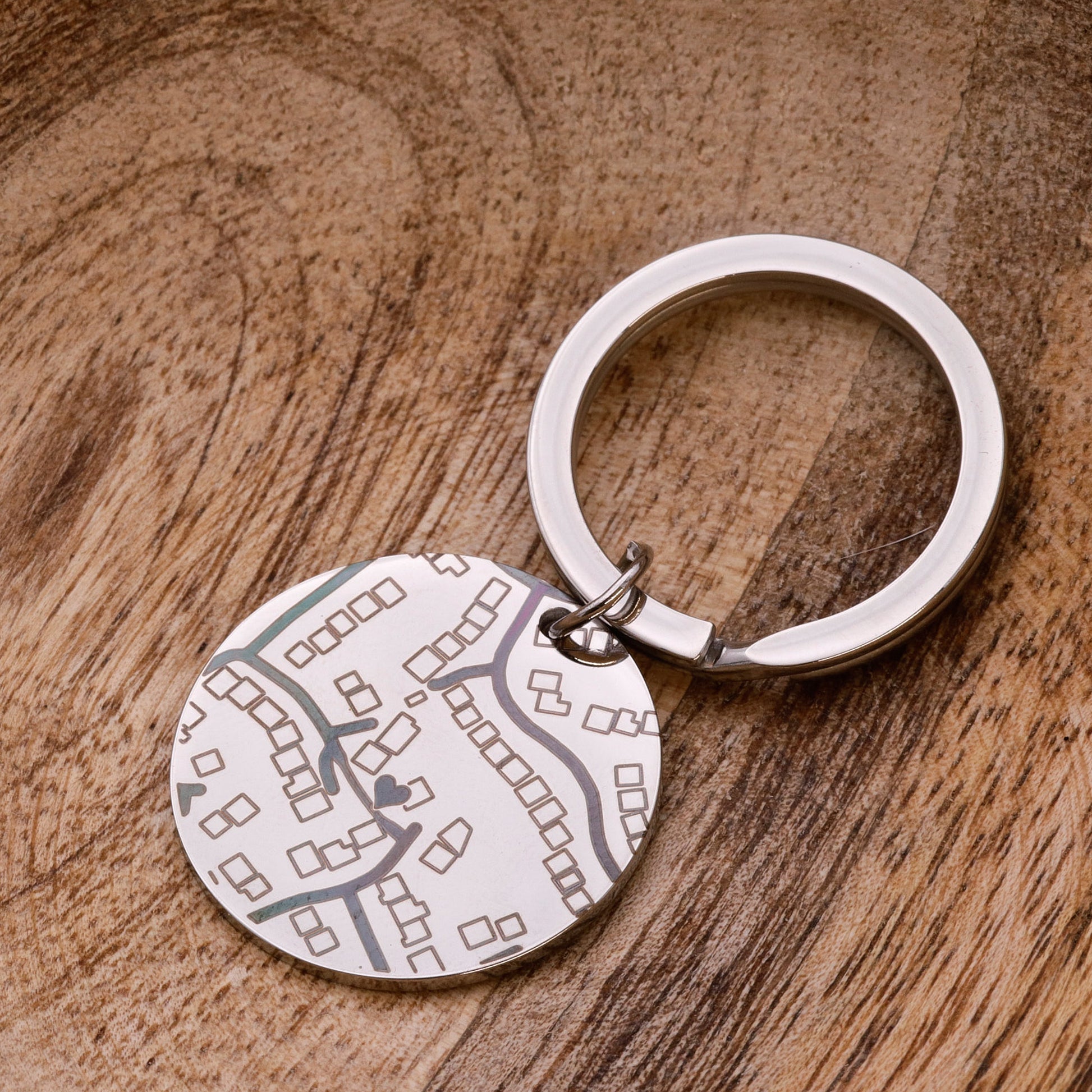 Keychain with a map design on a wooden surface
