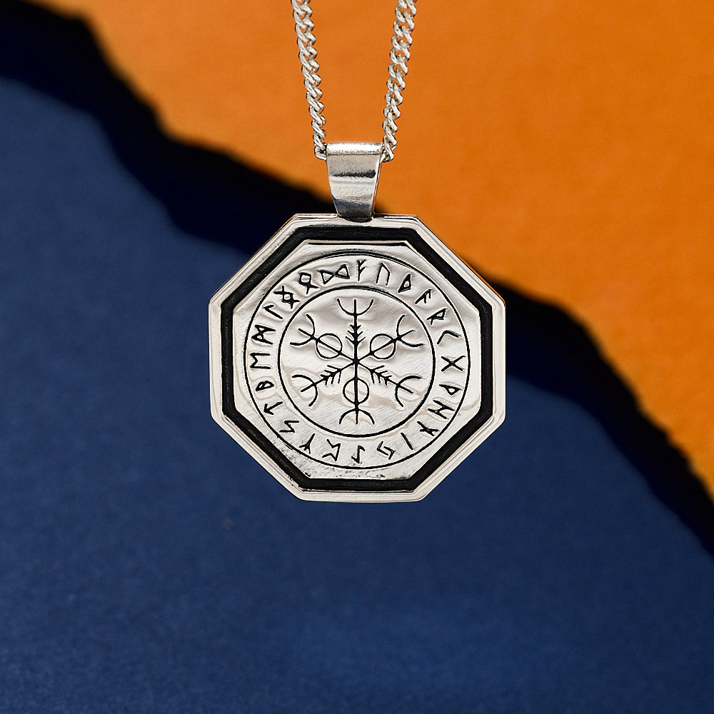 Silver oxidised vegvisir pendant with Runes on a blue and orange gradient background