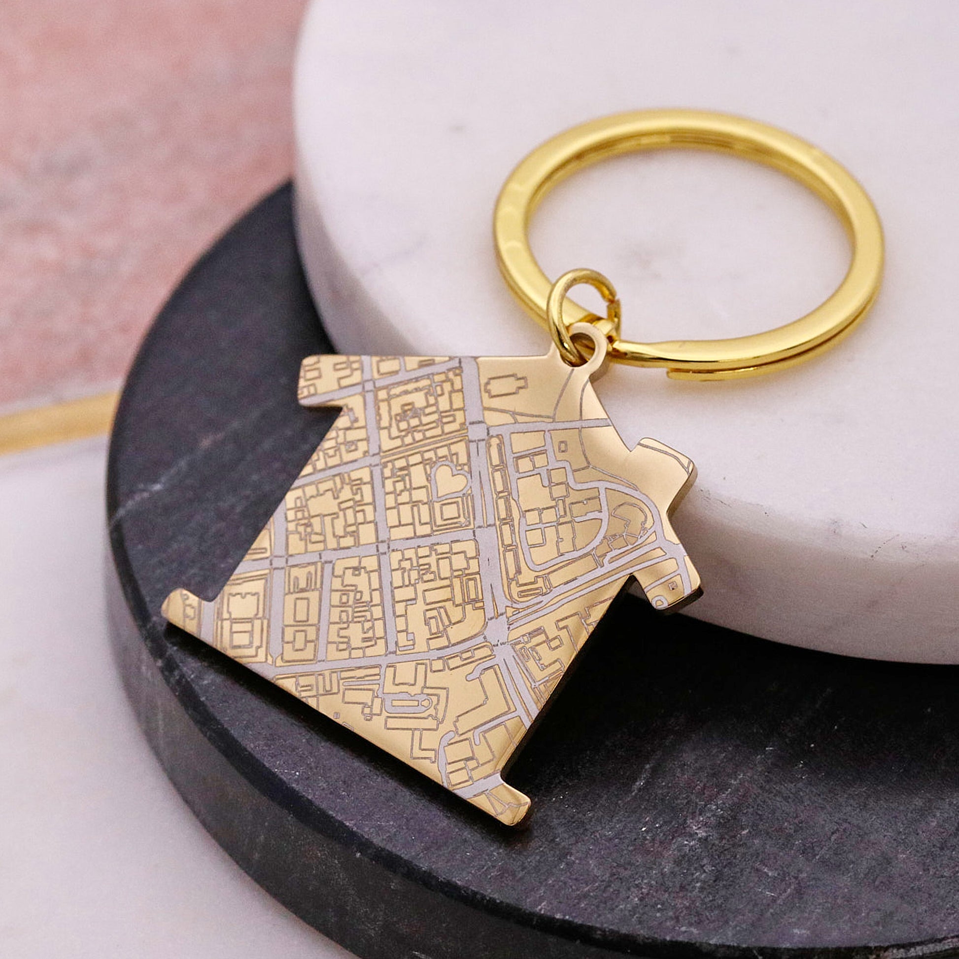 Gold house shaped silver keyring with map design