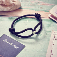 Wanderlust Vegan Paracord Bracelet in black with silver engraved wanderlust charm