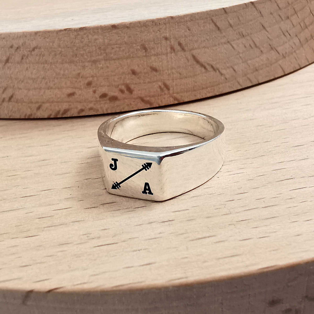 custom engraved bespoke signet ring with initials and arrow symbol