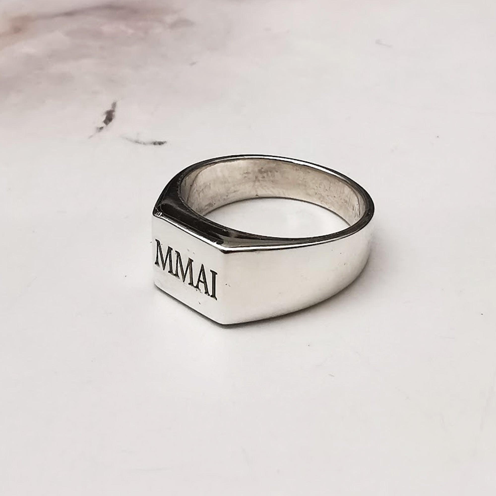 custom engraved silver ring with four initials in serif font