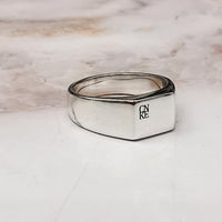 custom engraved silver ring with four initials in a block