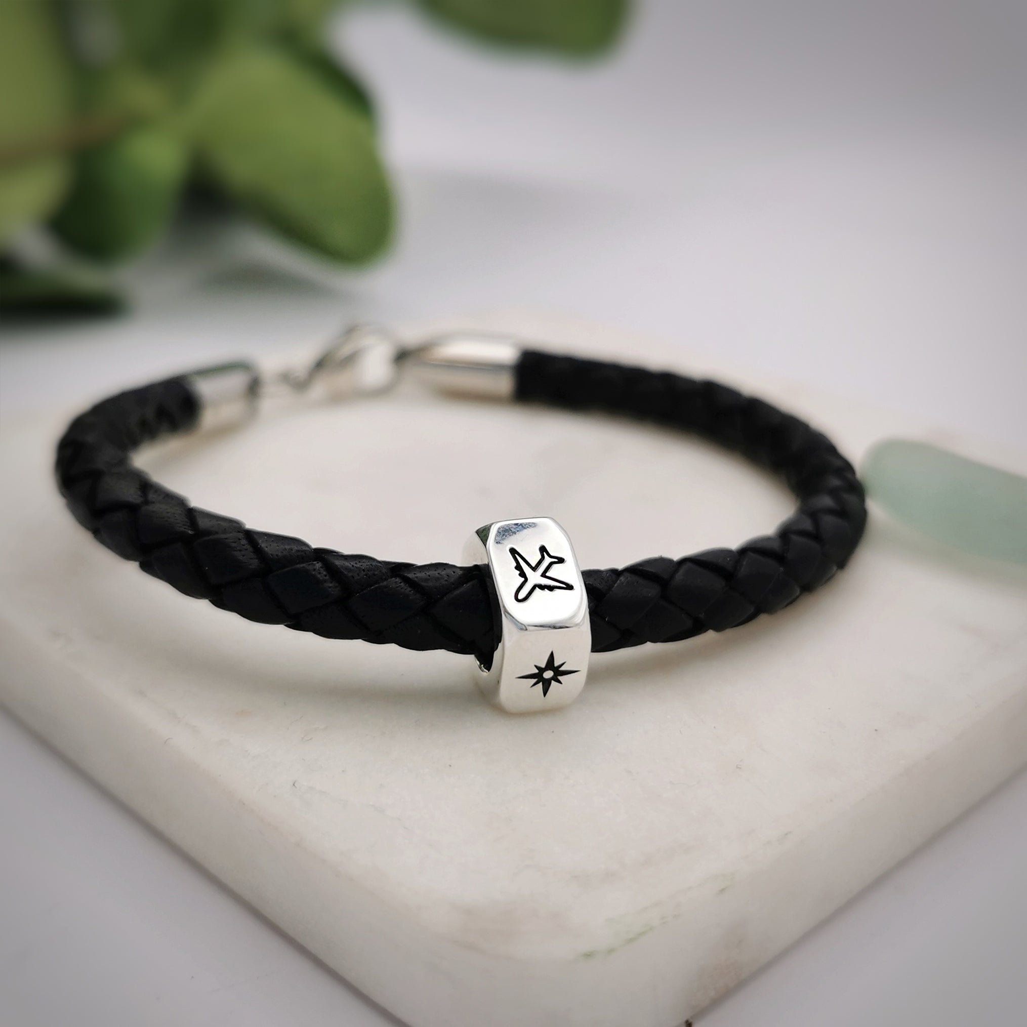 traveller charm bracelet with north star and aeroplane engraved